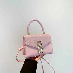 Pink patchwork crossbody bag with glitter flap and golden metallic clasp closure