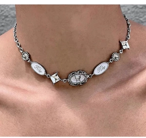 Detail of Y2K silver choker with butterfly pendants and Kiko engraved crystals