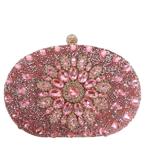 Pink rhinestone evening clutch bag with sunflower pattern and diamond clasp on white background