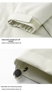 Detailed view of adjustable windproof cuffs and drawstring hem on an outdoor jacket