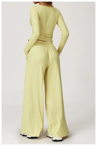 Back view of yellow tie-back yoga long sleeve set with flared fitness pants