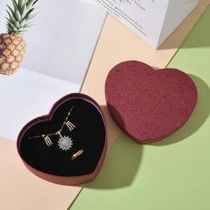 Red heart jewelry gift box with gold flower necklace, earrings, and ring set