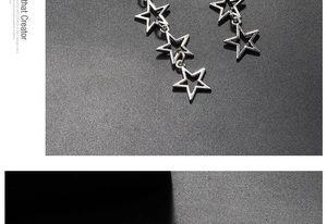 Macro shot of silver hollow star drop earrings featuring a polished minimalist chain link design