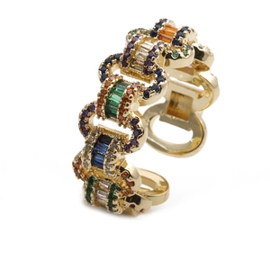 Detail of gold chain-link ring featuring vibrant rainbow zircon stones and open band