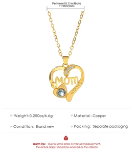 Detail of gold heart pendant with Mom lettering, diamonds, and Love You engraving