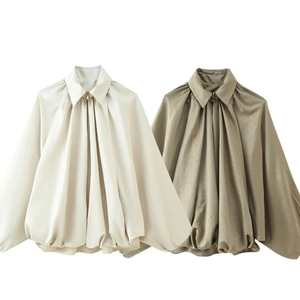 Women's puffer bomber jacket in cream and olive green with satin finish and puffy sleeves