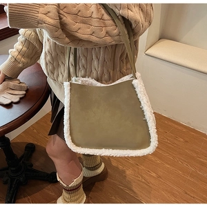 Detail of plush olive green suede shoulder bag with soft white faux shearling trim