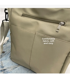 Detailed close-up of light green canvas bag showing high-quality stitching and soft fabric