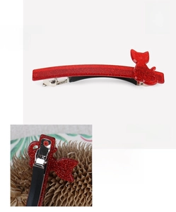 Detail of red glitter cat hair clip showing acrylic texture and 8.5cm metal spring clip