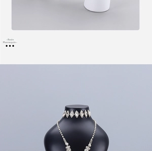 Detail of luxurious silver-tone rhinestone choker and necklace on a black mannequin