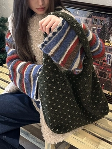 Green sherpa tote bag with white dots texture shown in a cozy autumn winter setting