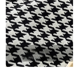 Macro shot of classic black and white houndstooth fabric texture with tight weaving
