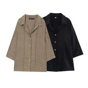 Detail of linen-textured shirts with vertical openwork stripes and buttoned cuffs