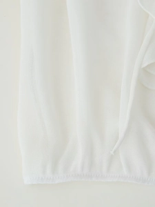 Close-up of lightweight white V-neck blouse showing breathable knit fabric texture