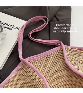 Close-up of pink woven handle and natural straw texture of the large tote bag