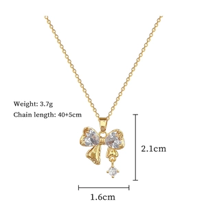 Detail view of golden bow pendant with dimensions 2.1x1.6cm and 3.7g weight