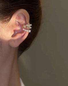 Close-up of gold-plated double-layer pearl ear cuff with zircon flower details on ear