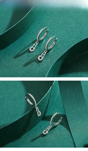 Detail of 925 sterling silver safety pin earrings with micro-inlaid zircon crystals
