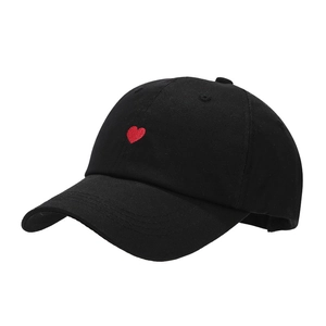 Classic black cotton baseball cap featuring a distinctive red heart embroidery on front
