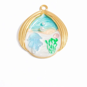 Macro detail of a gold seashell pendant with blue jellyfish and pearls in resin