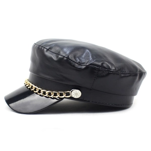 Women's black PU leather baker boy hat featuring a decorative chunky gold chain detail