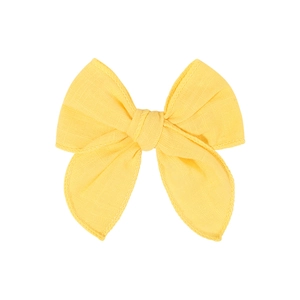 Detailed texture of bright yellow linen cotton bow hair clip with neat stitching edges