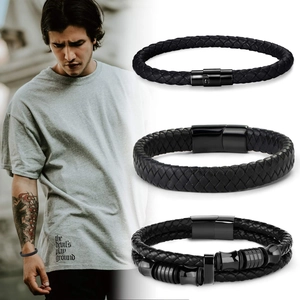 Detail view of men's black braided leather bracelets with magnetic clasps and steel beads
