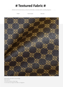 Detail of soft leather texture with golden four-leaf clover pattern on a brown bag
