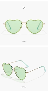 Front and 45-degree side views of gold metal heart sunglasses with light green lenses