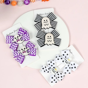 Detail of Halloween hair clips set featuring ghost and pumpkin bows on grosgrain ribbon