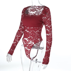 Detailed view of burgundy lace long sleeve bodysuit fabric pattern and floral embroidery
