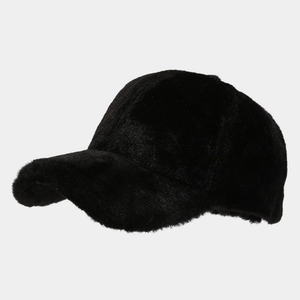 Detail of black faux fur baseball cap showing thick plush texture for winter warmth