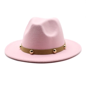 Pink wool fedora hat with a brown suede band and gold metallic studs on a white background
