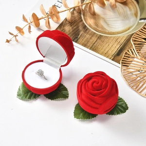 Elegant red rose-shaped velvet ring box with green leaves for jewelry gift presentation
