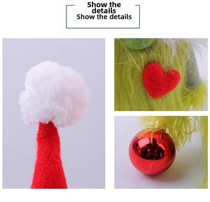 Detail of Christmas gnome with green long fur, red felt hat and shiny bauble ornament