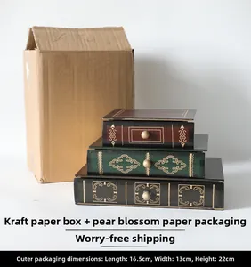 Three-piece vintage book-shaped storage drawers in deep wood tones with gold patterns