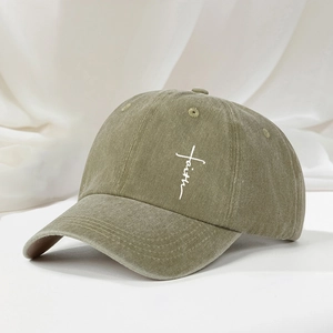 Close-up of olive green washed cotton baseball cap featuring faith cross embroidery