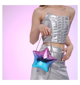 Detail of star-shaped evening bag featuring holographic blue-purple gradient and chain strap