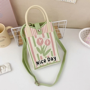 Detail of knitted tulip phone bag with Nice Day text and green adjustable shoulder strap