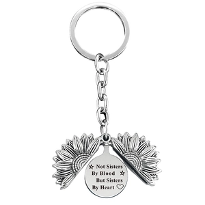 Detail of sunflower keychain with engraved sisters sentiment on inner pendant