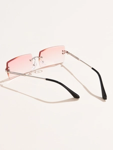 Detail view of rimless square sunglasses with pink gradient lenses and silver metal temples