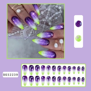 Detail of purple and neon green gradient press-on nails with celestial star patterns