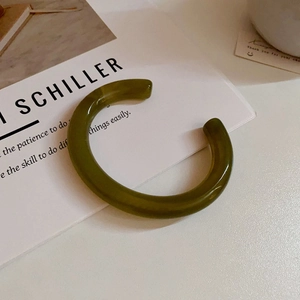 Minimalist dark green acrylic C-shape open bangle with smooth resin finish