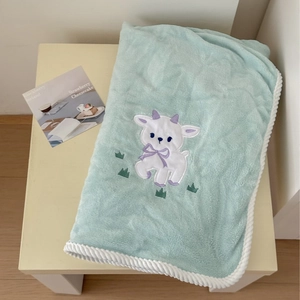 Soft mint green lamb embroidered bath towel with elegant white braided border finish