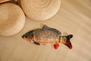Detailed realistic carp fish plush pillow cover with zipper on light wood flooring