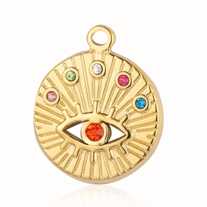 Macro detail of gold evil eye pendant with colorful rhinestones and red center stone