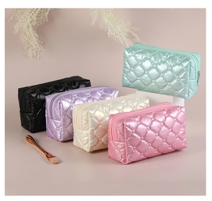Quilted nylon makeup bags in five pastel colors arranged in a stylish stepped layout