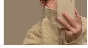 Close-up of beige knit headband featuring colorful heart and pearl embellishments