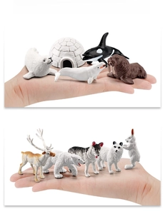 Detailed scale view of miniature polar animal models held in hand for size reference