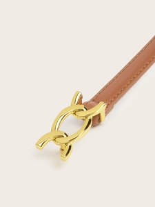 Close-up of a brown leather belt featuring a unique gold metal buckle and stitching details